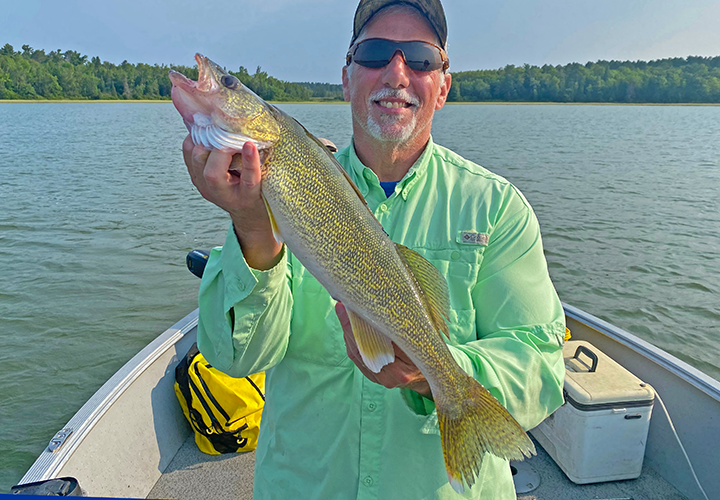 image of Phil Goettl holding nice walleye he caught on a fishing charter with pro guide Jeff Sundin