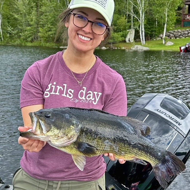 image of woman holding a big largemouth bass caught in the Ely MN area