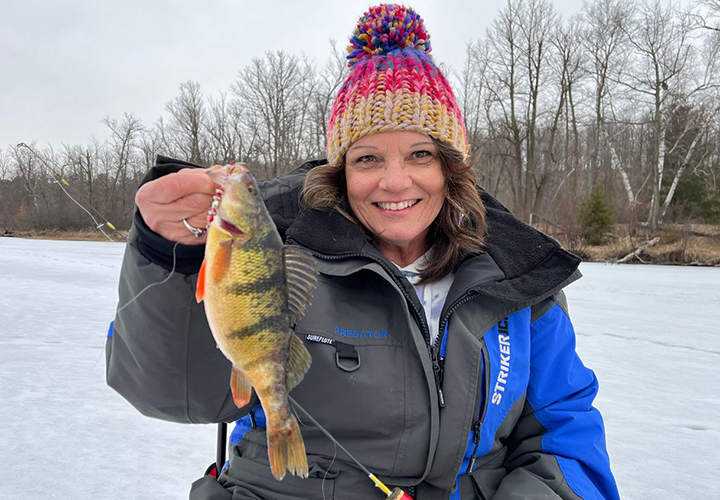 image of the hippie chick with big perch caught near grand rapids