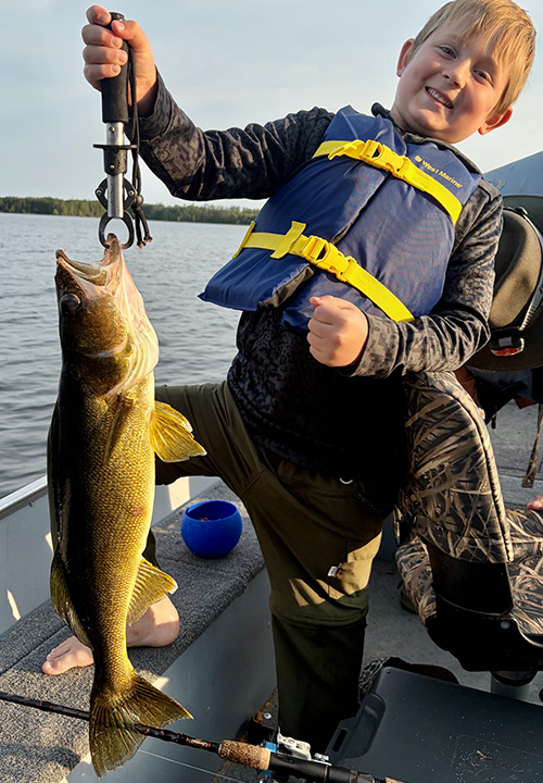 Image of raylan stanfield with a large walleye from Basswod Lake in Ely Minnesota