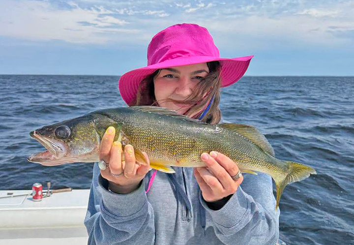 image of woman holding nice walleye she caught on Cyrus Resort fishing charter