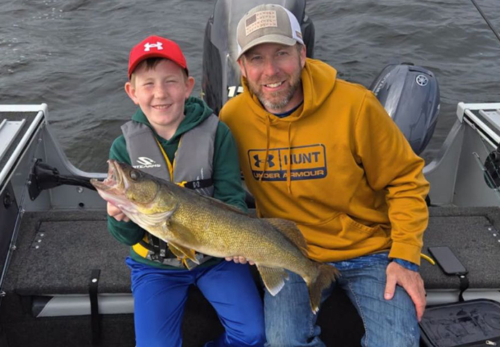 image of father and son with big walleye caught on Arnesen's Resort charter fishing trip