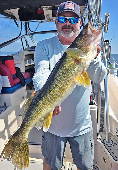 image of Tim Wingnut Hill showing off a huge walleye caught on Lake of the Woods