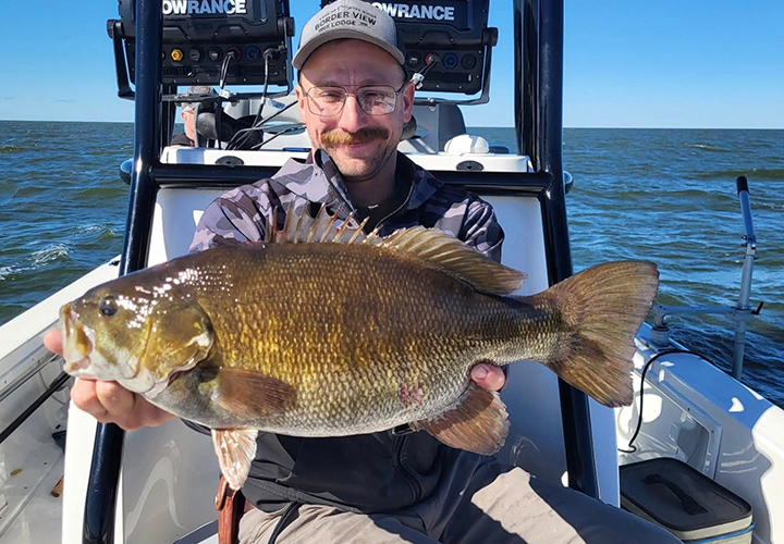 image of Captain Ben Barrus with a huge smallmouth caught on Lake of the Woods