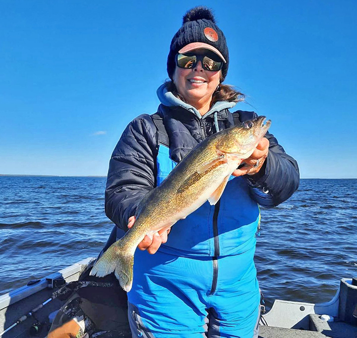 image of woman with a large walleye caught on Lake of the Woods 
