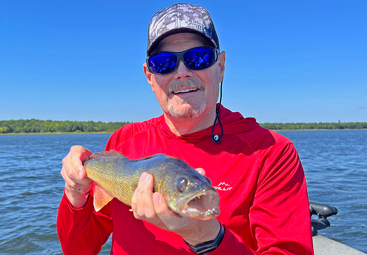 image of Rick with a walleye he caught on a fishing charter with Jeff Sundin 