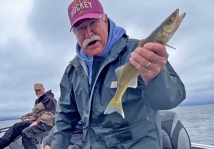 image of Mike Cooley with nice eating size walleye on Lake Winnie 